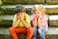 Small girl and boy on stairs. Relations. summer vacation. childhood first love. couple of little children. sad boy and Royalty Free Stock Photo