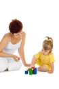 Small girl build pyramid with mother Royalty Free Stock Photo