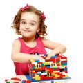 Small girl builds a house from plastic blocks Royalty Free Stock Photo