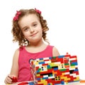 Small girl builds a house from plastic blocks Royalty Free Stock Photo