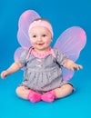 Small girl butterfly wings sitting on the floor Royalty Free Stock Photo