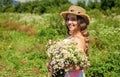 Small girl collecting flowers and herbs on sunny day, vacation concept Royalty Free Stock Photo