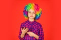 Small girl colorful wig use smartphone. positive and cheerful. childhood happiness. kid looking funny in rainbow wig Royalty Free Stock Photo