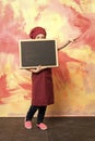 Small girl cook in hat with blackboard. Royalty Free Stock Photo