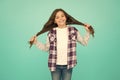 Small girl curly hairstyle. International childrens day. Little girl turquoise background. Good mood concept. Positive