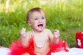 Small girl eating her first birthday cake and smiling Royalty Free Stock Photo