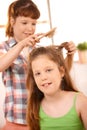 Small girl getting hair comb