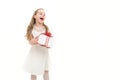 Small girl with gift box with red bow in dress. Royalty Free Stock Photo