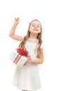 Small girl with gift box with red bow in dress. Royalty Free Stock Photo