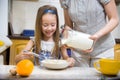 Small girl going to beat the dough for pancakes Royalty Free Stock Photo