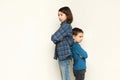 Small girl and her brother standing back to back Royalty Free Stock Photo