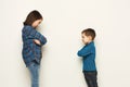 Small girl and her brother standing face to face Royalty Free Stock Photo