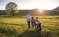 A small girl with her senior grandparents with wheelchair on a walk outside in nature. Royalty Free Stock Photo