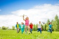 Small girl holding airplane toy and kids behind Royalty Free Stock Photo