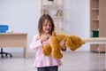 Small girl holding bear toy waiting for doctor in the clinic Royalty Free Stock Photo