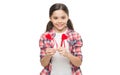 Small girl holding hearts on sticks. Cute girl with red hearts. Child hold heart decorations. Happy valentines day