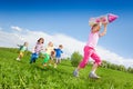 Small girl holding rocket carton toy and kids run Royalty Free Stock Photo