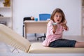 Small girl holding syringe waiting for doctor in the clinic Royalty Free Stock Photo