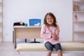 Small girl holding syringe waiting for doctor in the clinic Royalty Free Stock Photo