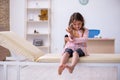 Small girl holding syringe waiting for doctor in the clinic Royalty Free Stock Photo