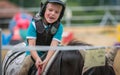 Small girl on horse focusing in training Royalty Free Stock Photo