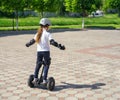 Small girl learns to ride electric mini hoverboard Royalty Free Stock Photo