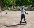 Small girl learns to ride electric mini hoverboard Royalty Free Stock Photo