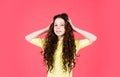 Small girl with long curly hair. fashion model kid has brunette hairstyle. hairdresser for child. shampoo cosmetic for Royalty Free Stock Photo