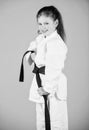 Small girl in martial arts uniform. little girl in gi sportswear. practicing Kung Fu. happy childhood. knockout. energy