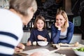 A small girl with mother and grandmother at home. Royalty Free Stock Photo