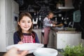 A small girl with mother and grandmother at home. Royalty Free Stock Photo