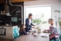 A small girl with mother and grandmother at home. Royalty Free Stock Photo