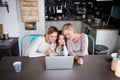 A small girl with mother and grandmother at home. Royalty Free Stock Photo