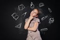 Small girl near chalkboard think of school subjects Royalty Free Stock Photo