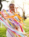 Small girl outdoors in garden in summer, playing with rainbow hand kite. Royalty Free Stock Photo