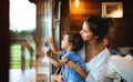 Small girl with parents in wooden cabin, holiday in nature concept. Royalty Free Stock Photo