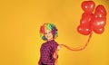 small girl in periwig. valentines day party. child wear rainbow wig hair yellow background. happy kid hold party