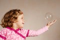 Small girl in pink dress with a bubble Royalty Free Stock Photo