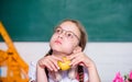 Small girl ready to eat apple. Smart child concept. healthy eating is good. small genius child in classroom. Lunch time Royalty Free Stock Photo