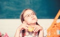 Small girl ready to eat apple. Smart child concept. healthy eating is good. small genius child in classroom. Lunch time Royalty Free Stock Photo