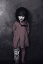 Small girl in a red dress and helmet in studio. Black and white Royalty Free Stock Photo