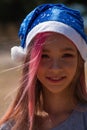 Small girl in santa hat with present have a christmas. little girl in red santa hat. Girl in santa hat Royalty Free Stock Photo