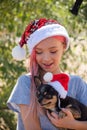 Small girl in santa hat with present have a christmas. little girl in red santa hat. Girl in santa hat Royalty Free Stock Photo