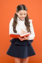 Small girl in school uniform. get information form book. back to school. Small girl with workbook for writing