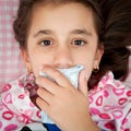 Small girl sick with the flu covering her mouth