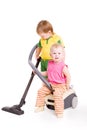 A small girl and a small boy by the Vacuum cleaner Royalty Free Stock Photo