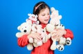 Small girl smiling face with toys. Happy childhood. Little girl play with soft toy teddy bear. Lot of toys in her hands