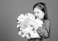 Small girl smiling face with toys. Happy childhood. Little girl play with soft toy teddy bear. Lot of toys in her hands Royalty Free Stock Photo