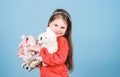 Small girl with soft bear toy. child psychology little girl play game in playroom. happy childhood. Birthday. hugging Royalty Free Stock Photo