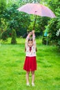 Small girl with umbrella in garden yard park, good weather concept Royalty Free Stock Photo